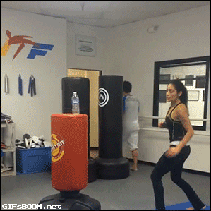 incredibly fit woman kicking water bottle